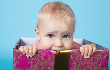 cute little girl sitting in box