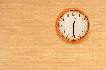 Clock showing 12:30 o'clock on a wooden wall