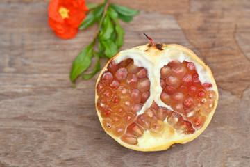 Juicy pomegranates on wood table.
