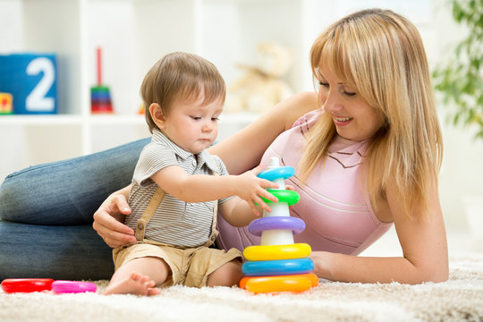 child and woman play together in nursery