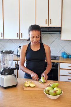 woman preparing fruit smoothie