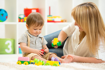 Fototapeta premium kid playing with building blocks at kindergarten