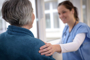 Nurse comforting elderly patient