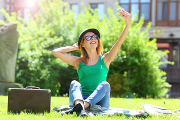 Woman taking a selfie in a summer park - shooting