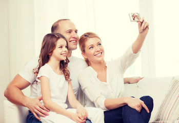 happy family with little girl making self portrait