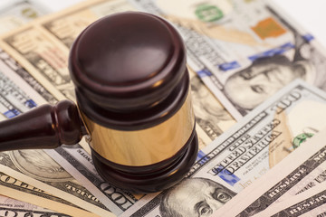 Judge gavel and dollar banknotes
