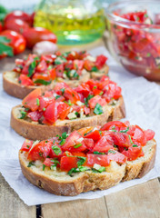 Bruschetta with tomatoes, herbs and oil on toasted garlic cheese bread