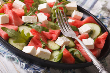 Delicious salad of watermelon, feta, arugula and cucumber closeup
