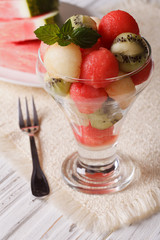 fruit balls of watermelon, kiwi and melon decorated with mint 
