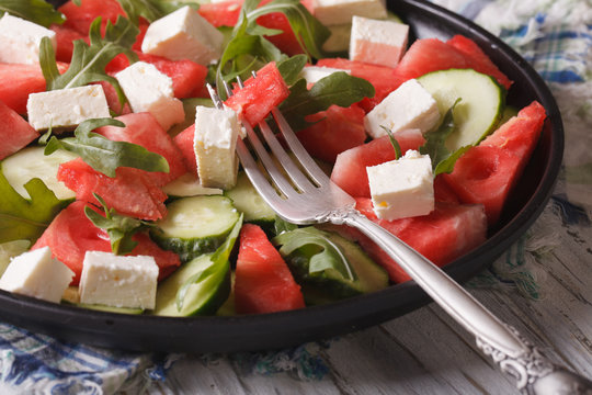 salad of watermelon, feta, arugula and cucumbers closeup. Horizontal
