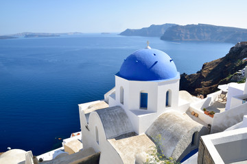 Blue sea and white church rooftop architecture in Oia Santorini - Greece