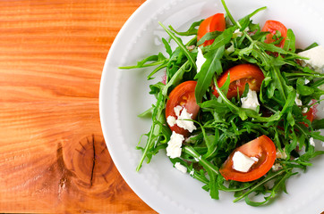 Green salad with arugula, tomatoes and feta cheese