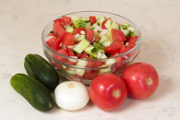 Vegetable salad with onion, tomato and cucumber