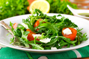 Green salad with arugula, tomatoes and feta cheese