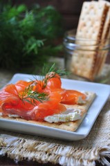 crackers with cheese curd, pickled salmon and dill