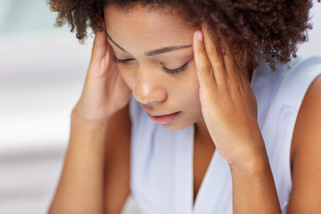 close up of african young woman touching her head