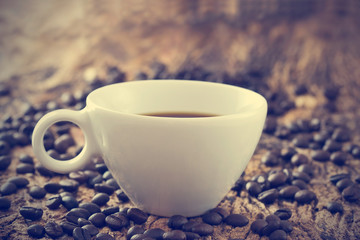 vintage color tone, coffee cup and beans on the old wooden