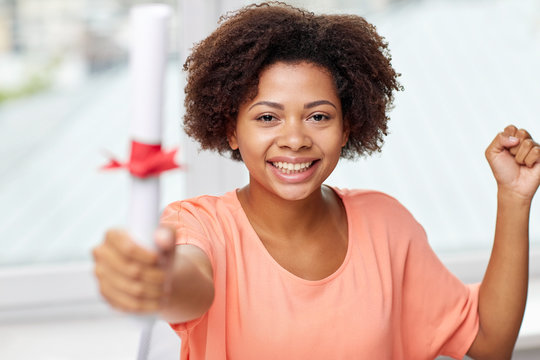 happy african american woman with diploma at home