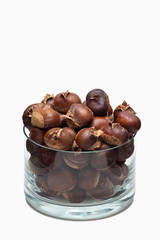 Roasted chestnuts in a glass dish