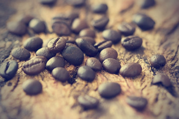 vintage color tone, coffee beans on the old wooden background