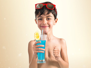 Child holding a blue drink © luismolinero
