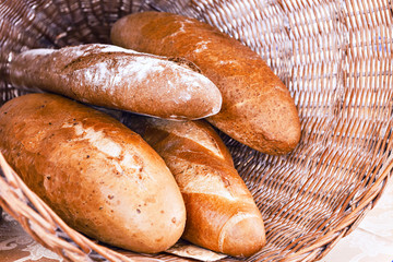 Rye and wheat bread loafs in a rustic braided basket