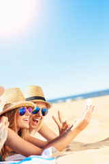 Group of friends taking selfie on the beach
