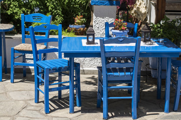 Traditional blue greek chairs in a backyard