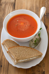 tomato soup in white bowl with bread