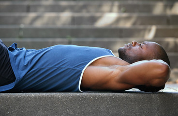 Man lying on back resting outside