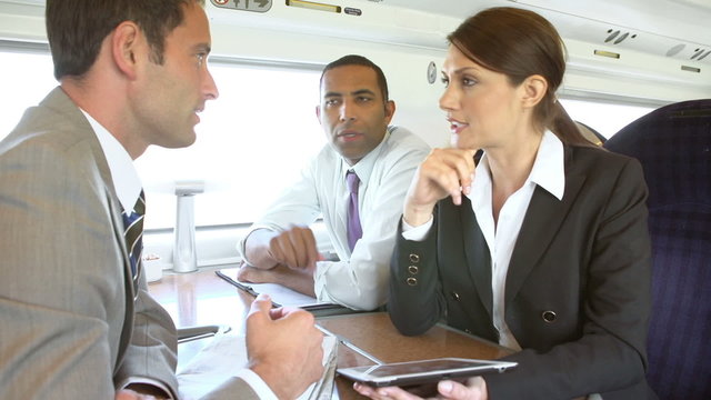 Group Of Businesspeople Having Meeting On Train
