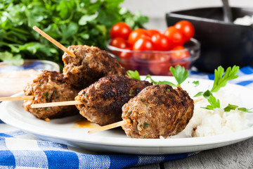 Barbecued kofta with rice on a plate