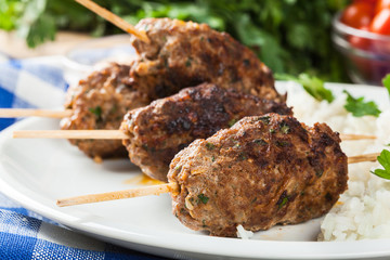 Barbecued kofta with rice on a plate