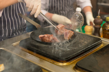 Chef cooking meat in a restaurant