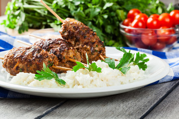 Barbecued kofta with rice on a plate