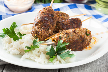 Barbecued kofta with rice on a plate