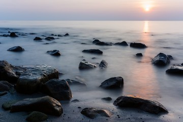 sunset in front of rocks on koh chang