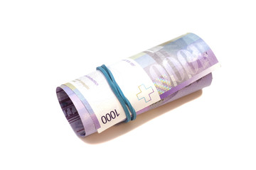 Swiss thousand francs in a roll on white background