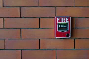 fire alarm on brick wall black
