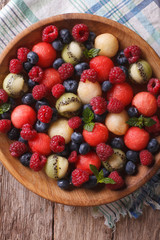salad of fresh fruits and berries closeup. vertical top view
