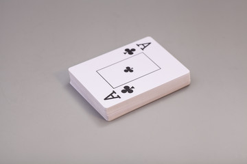 Playing cards with ace of clubs isolated on gray background