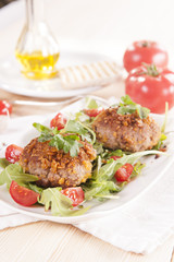 tasty chops with arugula and tomato 