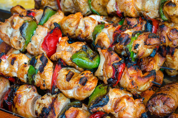 Skewers on wooden stick with tasty chicken meat and vegetables mix