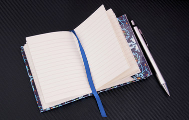 a notebook and pen on the desk