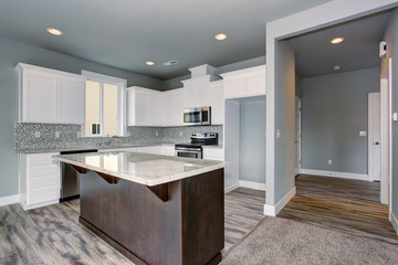 Unique kitchen with gray hardwood floor.