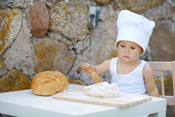 little boy with chef hat cooking