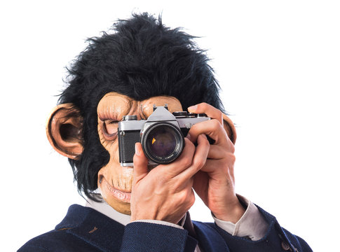 Monkey man photographing over white background