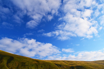 view on mountain range under thhe bright cloudy sky