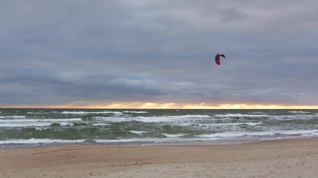 Kite Surfer is surfing the rough Baltic sea. Lithuania.