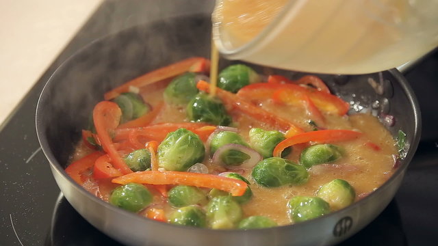 Omelette with Red Paprika, Brussel Sprouts and Onions Frying on a Pan